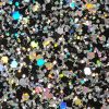 Glitter wallpaper encrusted with glitter pieces in a shade of black with iridescent particles from Glitter Bug Wallpaper.